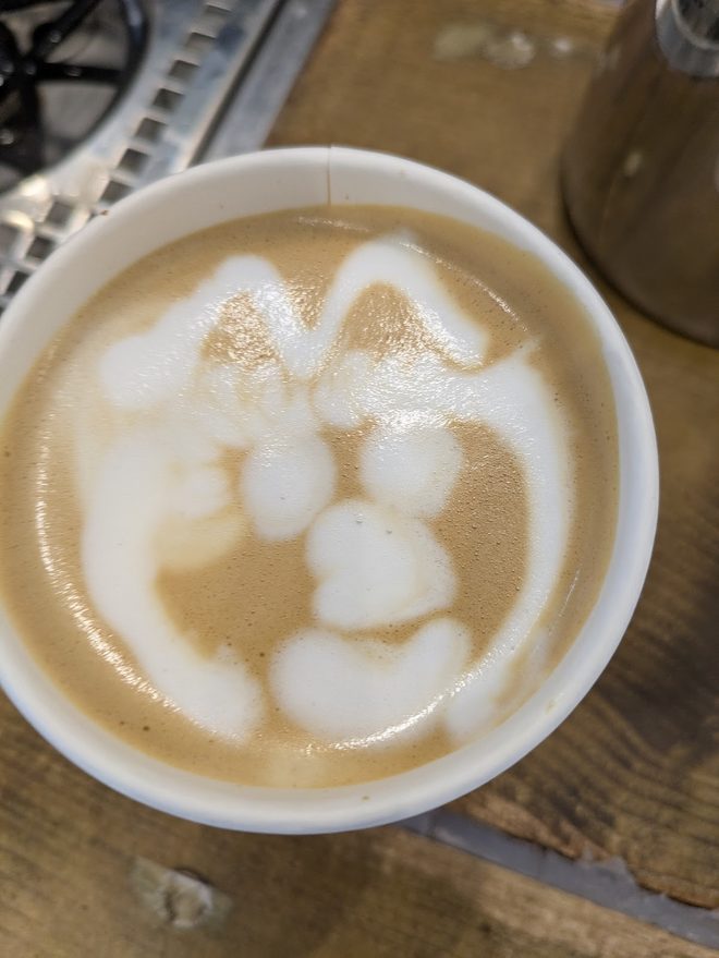 Coffee with a loose foam design in the milk
